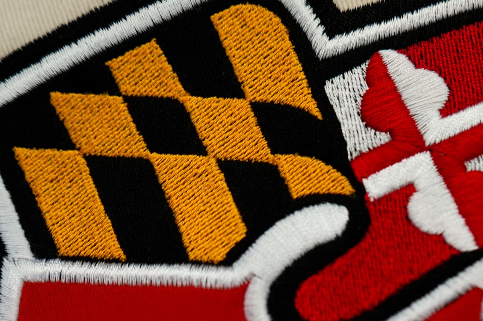 Macro of dense, consistent fill-stitch embroidery on tan fabric, showing the kind of clean digitizing work that doesn't cause production problems